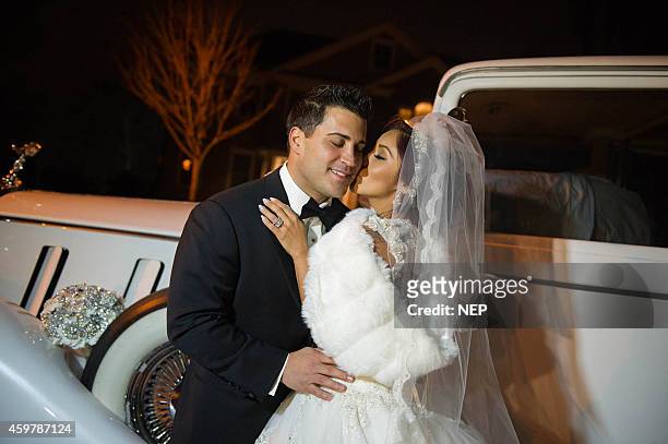 Nicole "Snooki" Polizzi and Jionni LaValle pose druign their wedding at St. Rose Of Lima on November 29, 2014 in East Hanover, New Jersey. Dress by...