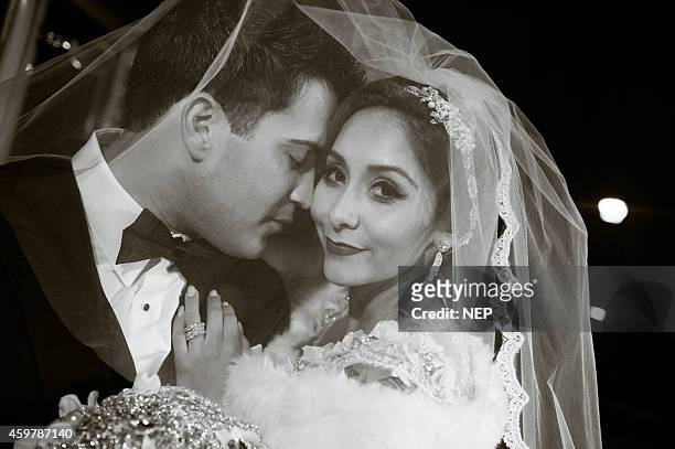 Nicole "Snooki" Polizzi and Jionni LaValle pose druign their wedding at St. Rose Of Lima on November 29, 2014 in East Hanover, New Jersey. Head piece...