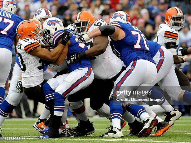 Running back Fred Jackson of the Buffalo Bills is tackled by linebacker Craig Robertson and defensive tackle Ishmaa'ily Kitchen of the Cleveland...