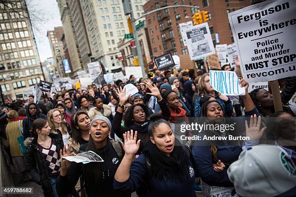 People protesting the Ferguson grand jury decision to not indict officer Darren Wilson in the Michael Brown case march through the streets on...
