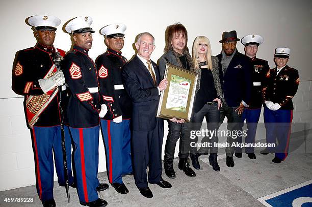 Retired Marine Lieutenant General Pete Osman, President and CEO of the Marine Toys for Tots Foundation, guitarist Richie Sambora, and Orianthi attend...