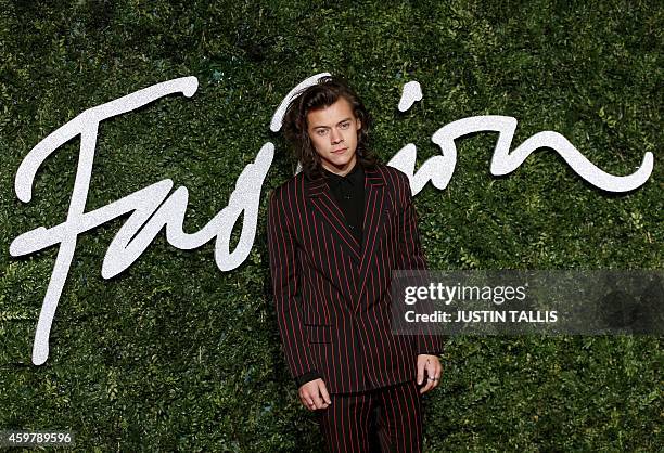 One Direction's Harry Styles poses for pictures on the red carpet upon arrival to attend the British Fashion Awards 2014 in London on December 1,...