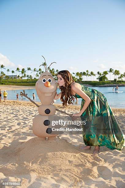 In this handout photo provided by Disney Parks, 'Austin & Ally' star Laura Marano is photographed on the beach at Aulani, a Disney Resort & Spa,...