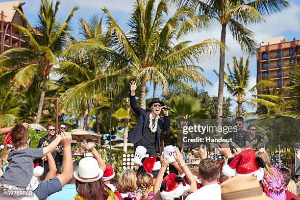 In this handout photo provided by Disney Parks, Gavin DeGraw performs 'I'll Be Home For Christmas' at Aulani, a Disney Resort & Spa, during...