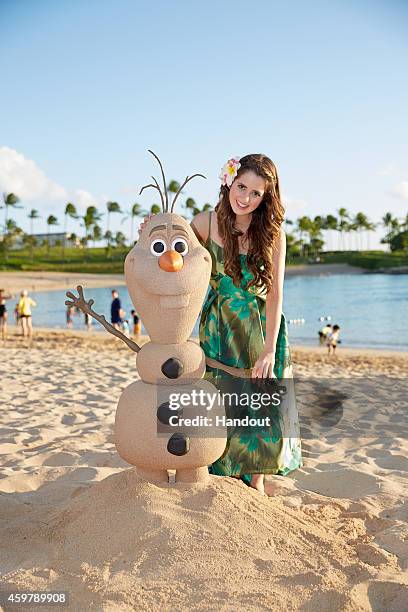 In this handout photo provided by Disney Parks, 'Austin & Ally' star Laura Marano is photographed on the beach at Aulani, a Disney Resort & Spa,...