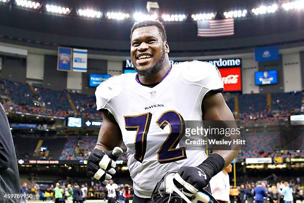 Kelechi Osemele of the Baltimore Ravens jogs off the field with a big smile after a win against the New Orleans Saints at Mercedes-Benz Superdome on...