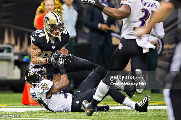 Kenny Stills of the New Orleans Saints goes to catch a pass in the third quarter over Danny Gorrer of the Baltimore Ravens at Mercedes-Benz Superdome...