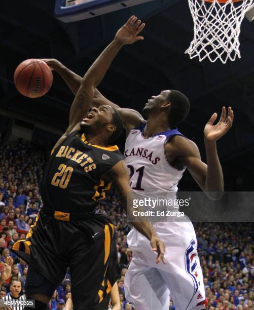 Julius Brown of the Toledo Rockets has his shot blocked by Joel Embiid of the Kansas Jayhawks the second half at Allen Fieldhouse on December 30,...