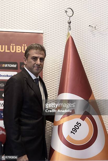 Hamza Hamzaoglu poses next to Galatasaray SK flag after he and Galatasaray SK signed for the new football coaching of the Galatasaray Professional...