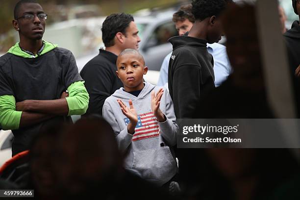 Members of the fire-damaged Flood Christian Church attend Sunday service in a tent in a nearby parking lot on November 30, 2014 in Ferguson,...