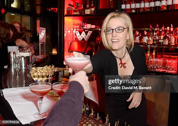 Gillian Anderson serves cocktails at the W London - Leicester Square & World AIDS Day Fundraising Party at Wyld on December 1, 2014 in London,...