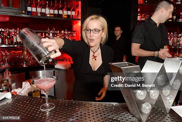 Gillian Anderson serves cocktails at the W London - Leicester Square & World AIDS Day Fundraising Party at Wyld on December 1, 2014 in London,...