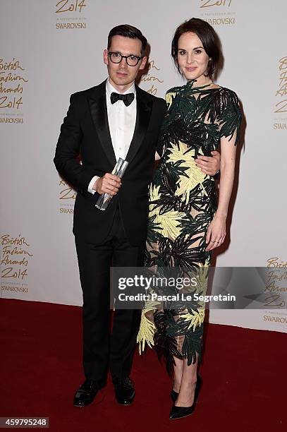 Womenswear winner designer Erdem Moralioglu and Michelle Dockery pose in the winners room at the British Fashion Awards at London Coliseum on...