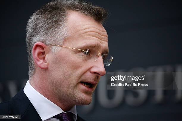 Prosecutor Wouter Bos talks to a journalists in front of the courthouse ahead of the verdict of three Jihad recruiters, where people are seen...