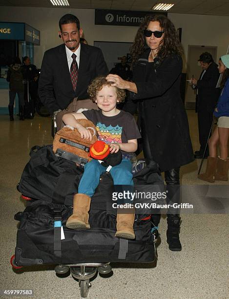 Minnie Driver and her son Henry Story Driver are seen at Los Angeles International airport on December 30, 2013 in Los Angeles, California.