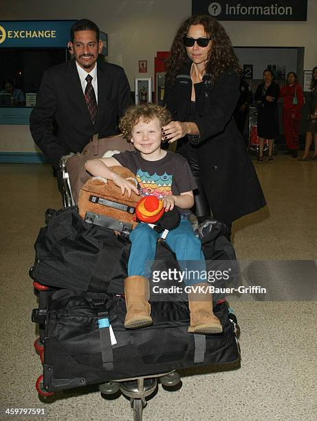 Minnie Driver and her son Henry Story Driver are seen at Los Angeles International airport on December 30, 2013 in Los Angeles, California.