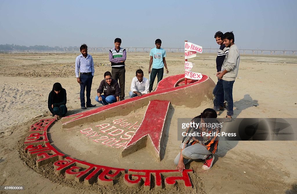 Allahabad University students make a sand sculpture on the...