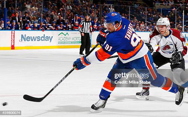 John Tavares of the New York Islanders takes a shot on goal in a game against the Colorado Avalanche at Nassau Veterans Memorial Coliseum on November...