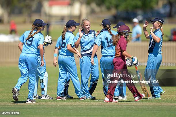 Naomi Woods of NSW Metropolitan celebrates taking the wicket of Charli Knott of Queensland during the Under 15 female championship match between NSW...