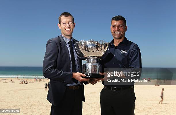 Former Socceroos Brett Emerton and John Aloisi pose with the Asian Cup trophy during the Fox Sports Asian Cup coverage launch at Bondi Beach on...