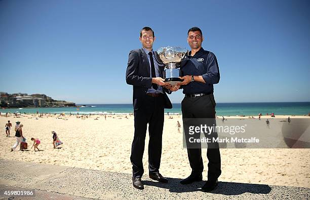 Former Socceroos Brett Emerton and John Aloisi pose with the Asian Cup trophy during the Fox Sports Asian Cup coverage launch at Bondi Beach on...