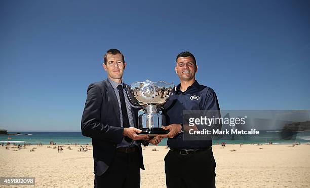 Former Socceroos Brett Emerton and John Aloisi pose with the Asian Cup trophy during the Fox Sports Asian Cup coverage launch at Bondi Beach on...