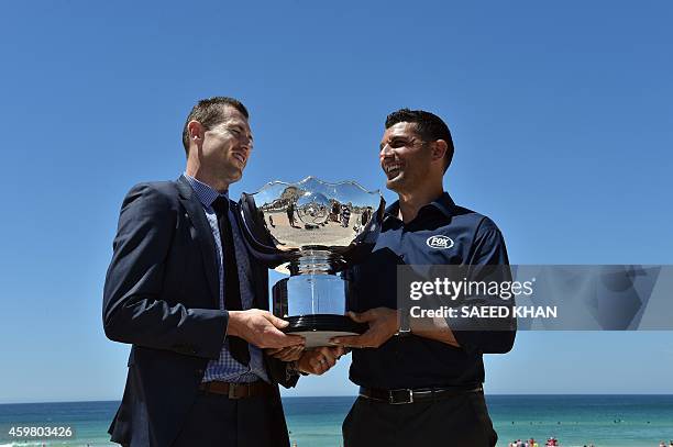 Former Australian Socceroos football players Brett Emerton and John Aloisi pose with the Asian Cup trophy at the Fox Sports Asian Cup coverage launch...