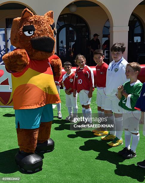 An official mascot for the AFC Asian Cup Australia "Nutmeg" plays with children during the Fox Sports Asian Cup football coverage launch at Bondi...