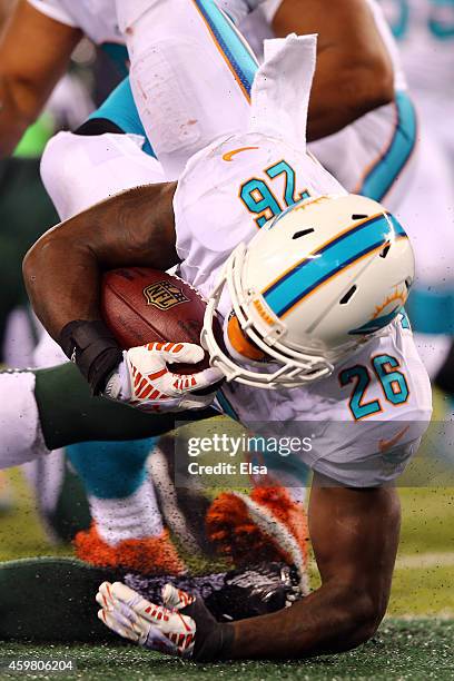 Lamar Miller of the Miami Dolphins scores a 4 yard touchdown in the fourth quarter to tie the game against the New York Jets at MetLife Stadium on...