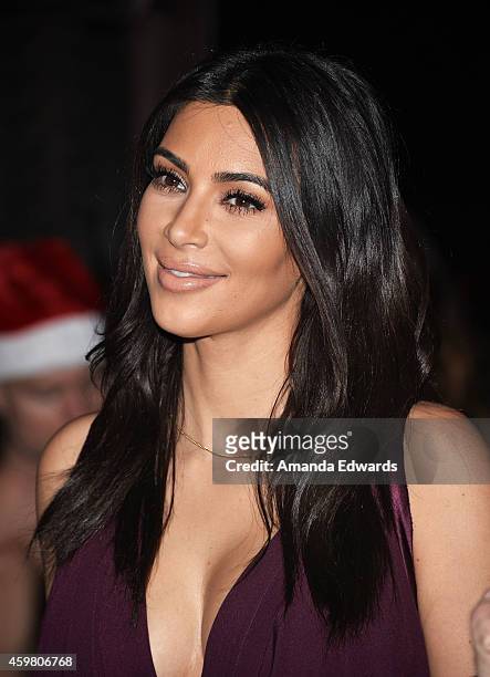 Television personality Kim Kardashian raises a toast for the Elizabeth Taylor Foundation/World AIDS Day at The Abbey on December 1, 2014 in West...
