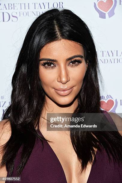 Television personality Kim Kardashian poses after raising a toast to the Elizabeth Taylor Foundation/World AIDS Day at The Abbey on December 1, 2014...