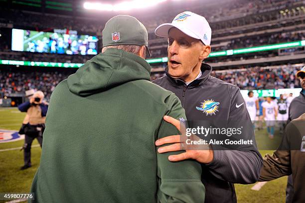 Head coach Joe Philbin of the Miami Dolphins shakes hands with head coach Rex Ryan of the New York Jets after their game at MetLife Stadium on...