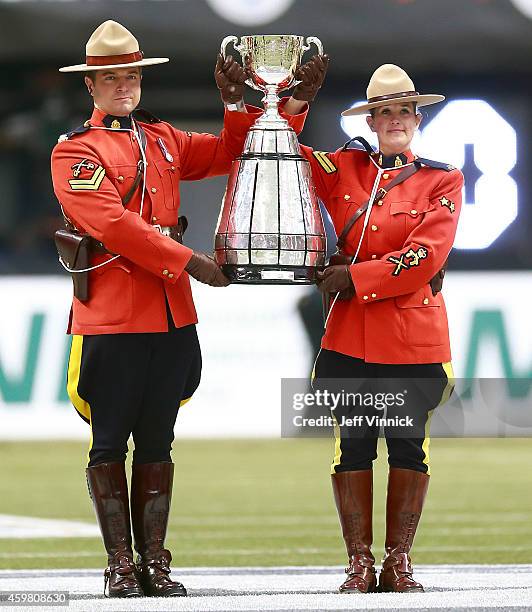 Officers carries the Grey Cup onto the field during the 102nd Grey Cup Championship Game at BC Place November 30, 2014 in Vancouver, British...