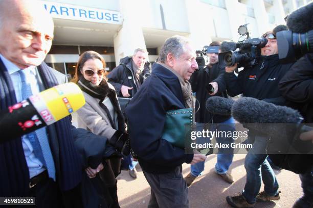 President Jean Todt, his wife actress Michelle Yeoh and surgeon and Michael Schumacher's friend professor Gerard Saillant leave the Grenoble...