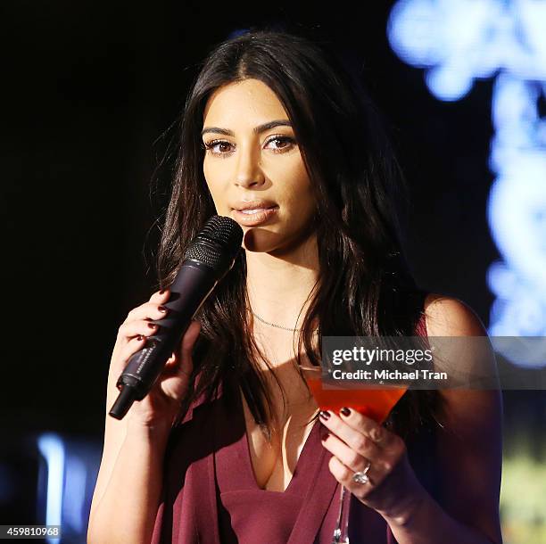 Kim Kardashian raises a toast for Elizabeth Taylor Foundation/World AIDS Day held at The Abbey on December 1, 2014 in West Hollywood, California.