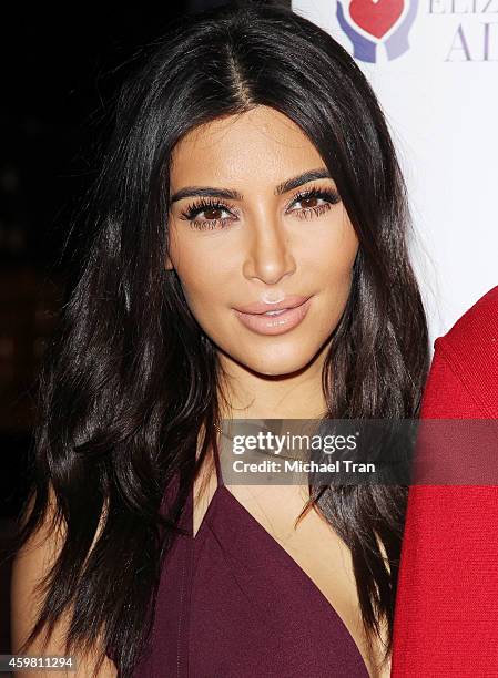 Kim Kardashian raises a toast for Elizabeth Taylor Foundation/World AIDS Day held at The Abbey on December 1, 2014 in West Hollywood, California.