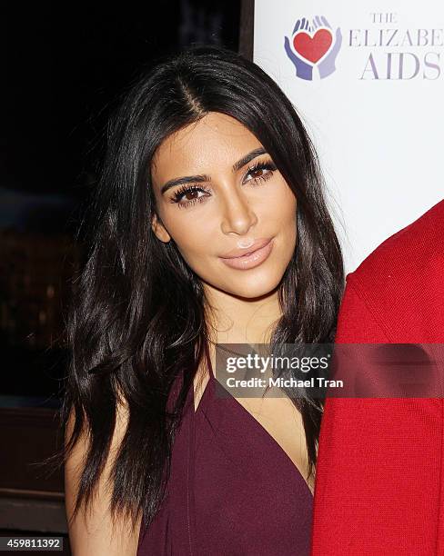 Kim Kardashian raises a toast for Elizabeth Taylor Foundation/World AIDS Day held at The Abbey on December 1, 2014 in West Hollywood, California.