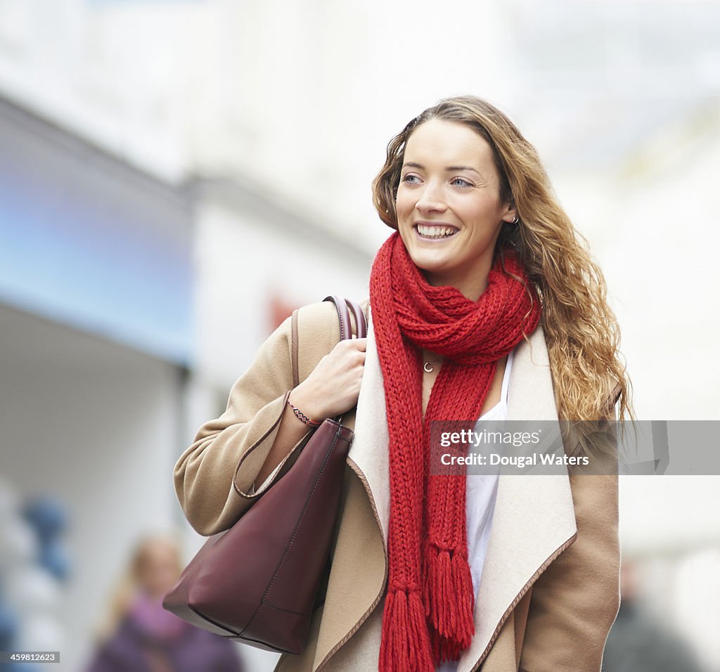 Woman smiling on shopping street.