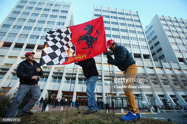 Ferrari fans set up flags outside the Grenoble University Hospital Centre where former German Formula One driver Michael Schumacher is being treated...