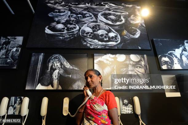 Bhopal Gas disaster survivor Vishnu Bai listens to her taped audio testament at the Remember Bhopal museum in Bhopal on December 2, 2014. The oral...