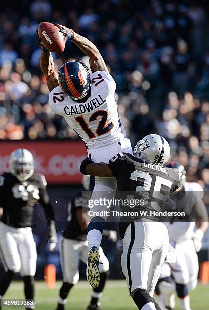 Andre Caldwell of the Denver Broncos catches this pass over Chimdi Chekwa of the Oakland Raiders during the first quarter at O.co Coliseum on...