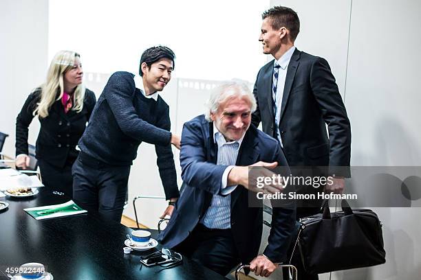 Heung-Min Son and Manager Rudi Voeller of Bayer Leverkusen shake hands with referee Daniel Siebert prior to the decision of DFB Court on the...