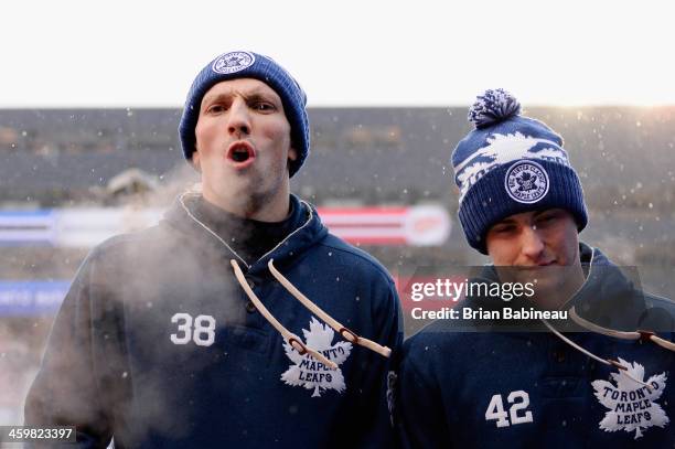 Frazer McLaren and Tyler Bozak of the Toronto Maple Leafs walk back to the player's locker room prior to the 2014 Bridgestone NHL Winter Classic team...