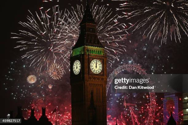 Fireworks light up the London skyline and Big Ben just after midnight on January 1, 2014 in London, England. Thousands of people lined the banks of...