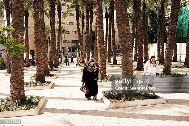 People walk along a street near the Old City on December 02, 2014 in Jerusalem, Israel. As violence continues in Israel, an Israeli was stabbed and...