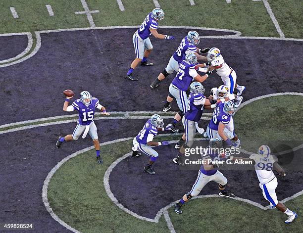 Quarterback Jake Waters of the Kansas State Wildcats drops back to pass against the Kansas Jayhawks during the first half on November 29, 2014 at...