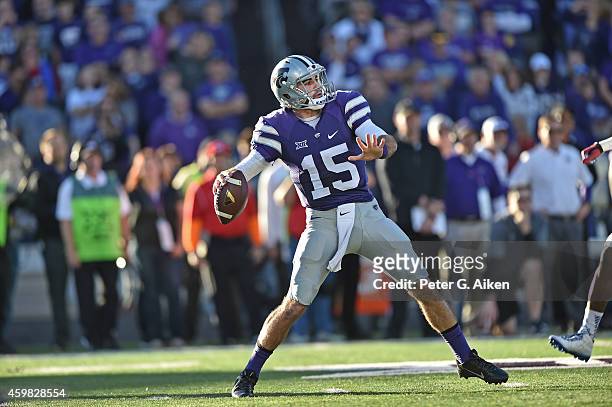 Quarterback Jake Waters of the Kansas State Wildcats drops back to pass against the Kansas Jayhawks during the first half on November 29, 2014 at...