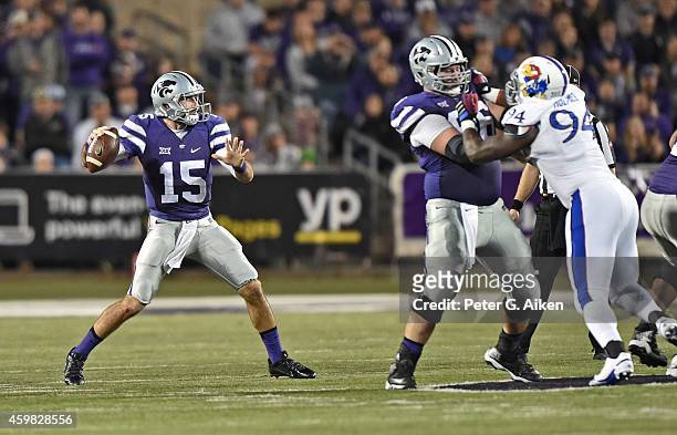 Quarterback Jake Waters of the Kansas State Wildcats drops back to pass against the Kansas Jayhawks during the second half on November 29, 2014 at...