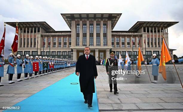 Turkish President Recep Tayyip Erdogan walks to welcome Russian President Vladimir Putin during the official welcoming ceremony at Turkey's...