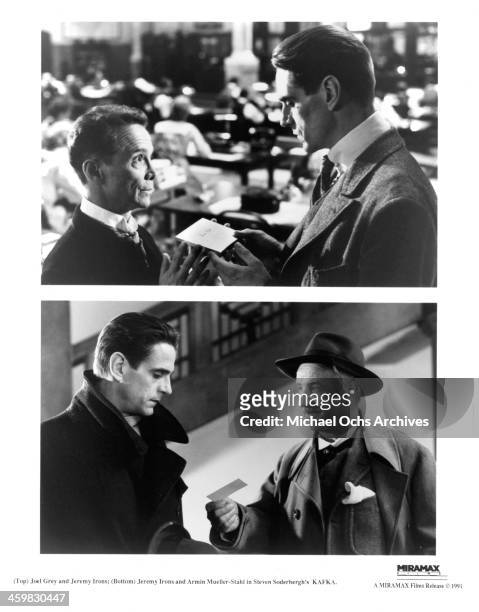 Actors Joel Grey and Jeremy Irons on set actor Jeremy Irons and Armin Mueller-Stahl of the movie "Kafka" , circa 1991.